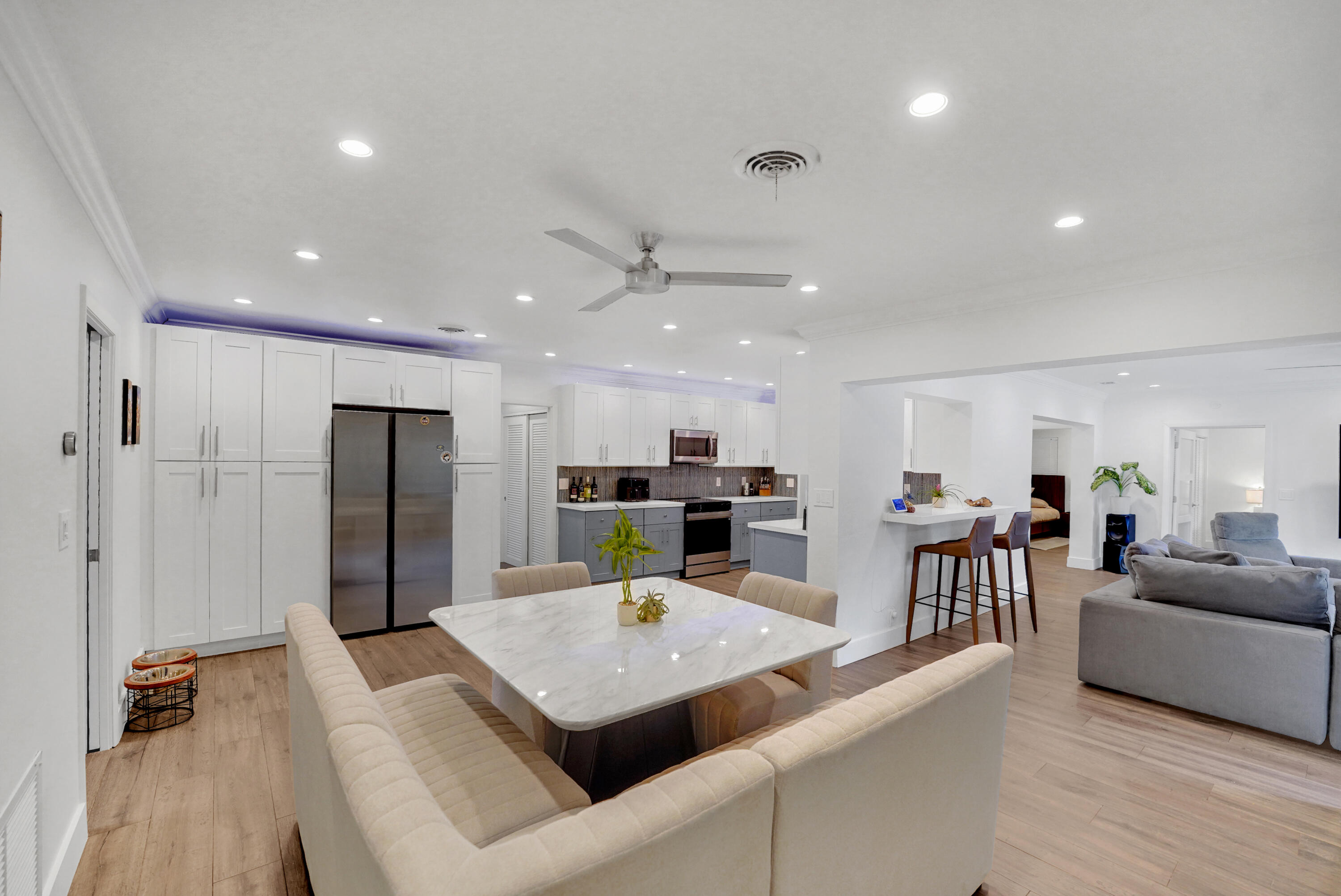 Kitchen featuring white cabinetry,recessed lighting, a breakfast bar, and stainless steel appliances