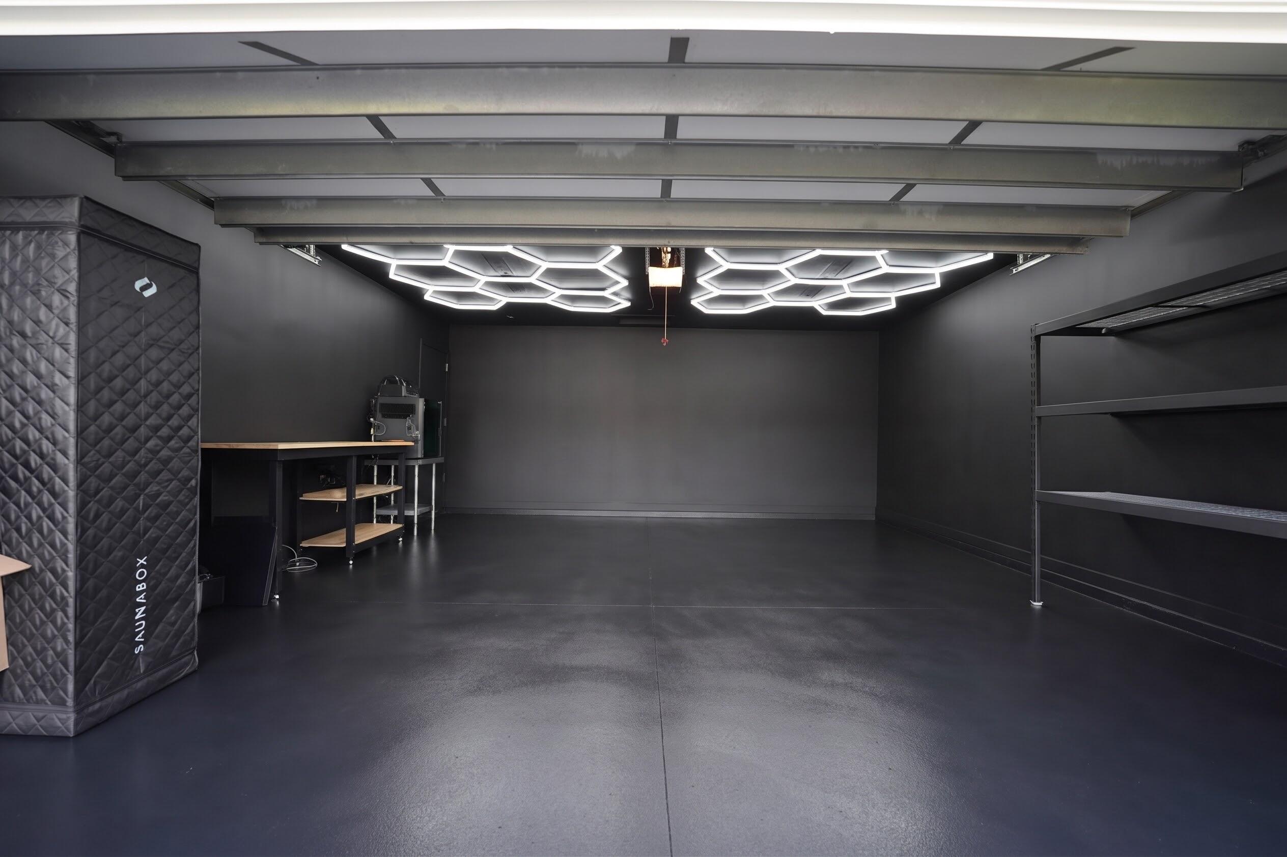 Updated garage with New paint, epoxy flooring and modern lighting.