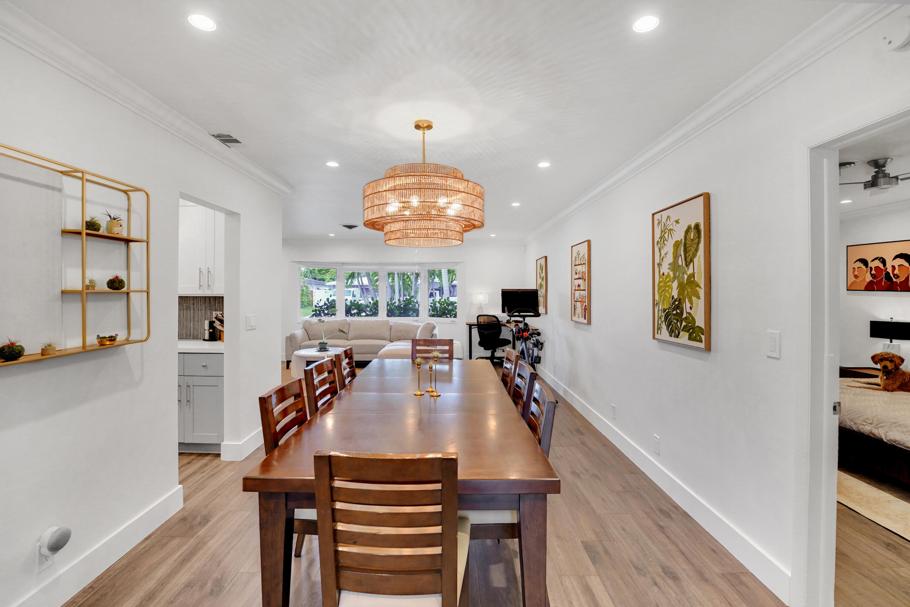 Multi-purpose room featuring wood-finish flooring, recessed lighting, crown molding, and a tiered drum chandelier