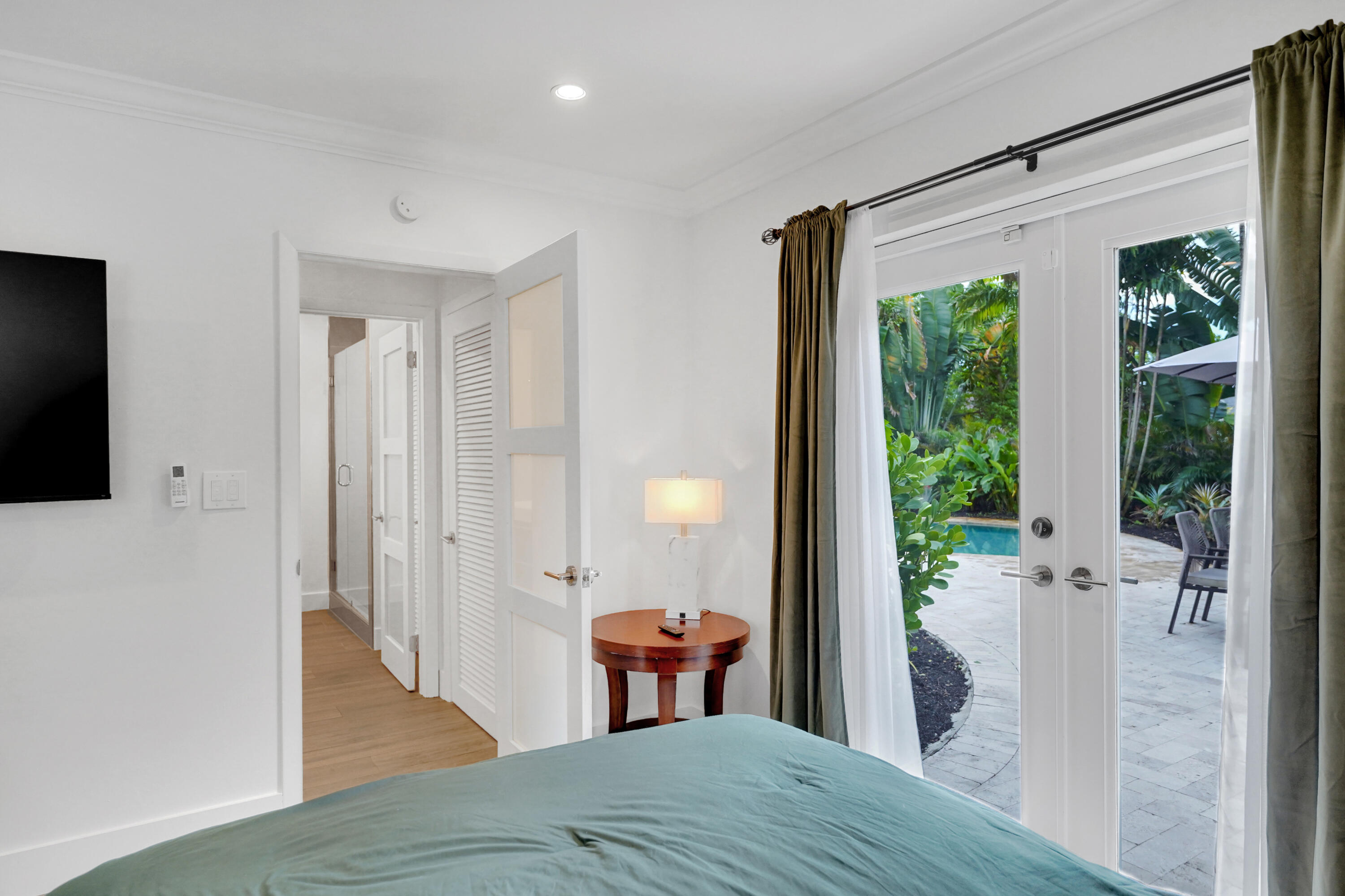 French doors with glass paneling, crown molding, louvered closet doors, and recessed lighting