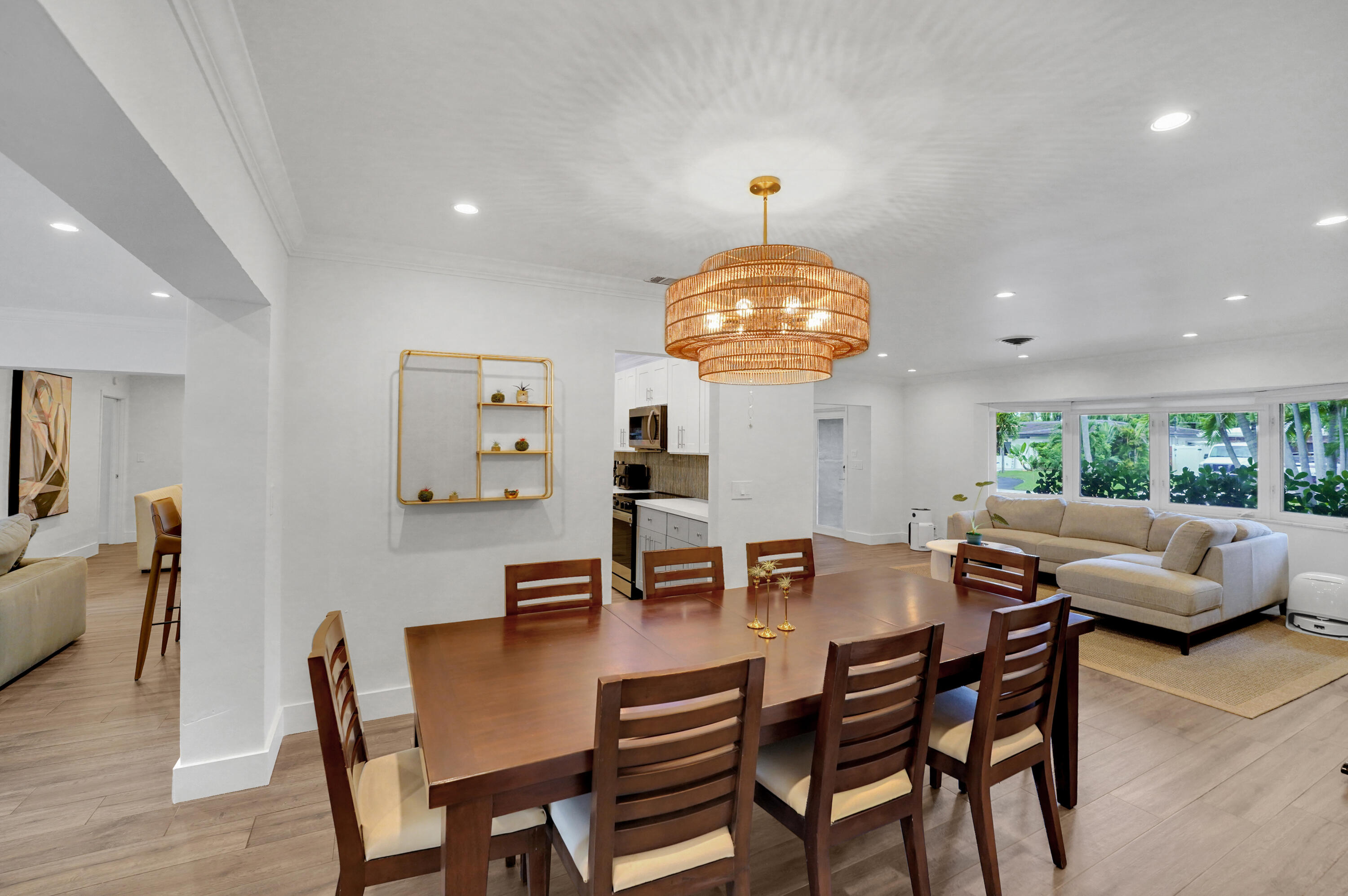 Open-concept area featuring recessed lighting, a tiered woven pendant light fixture, and large multi-pane windows