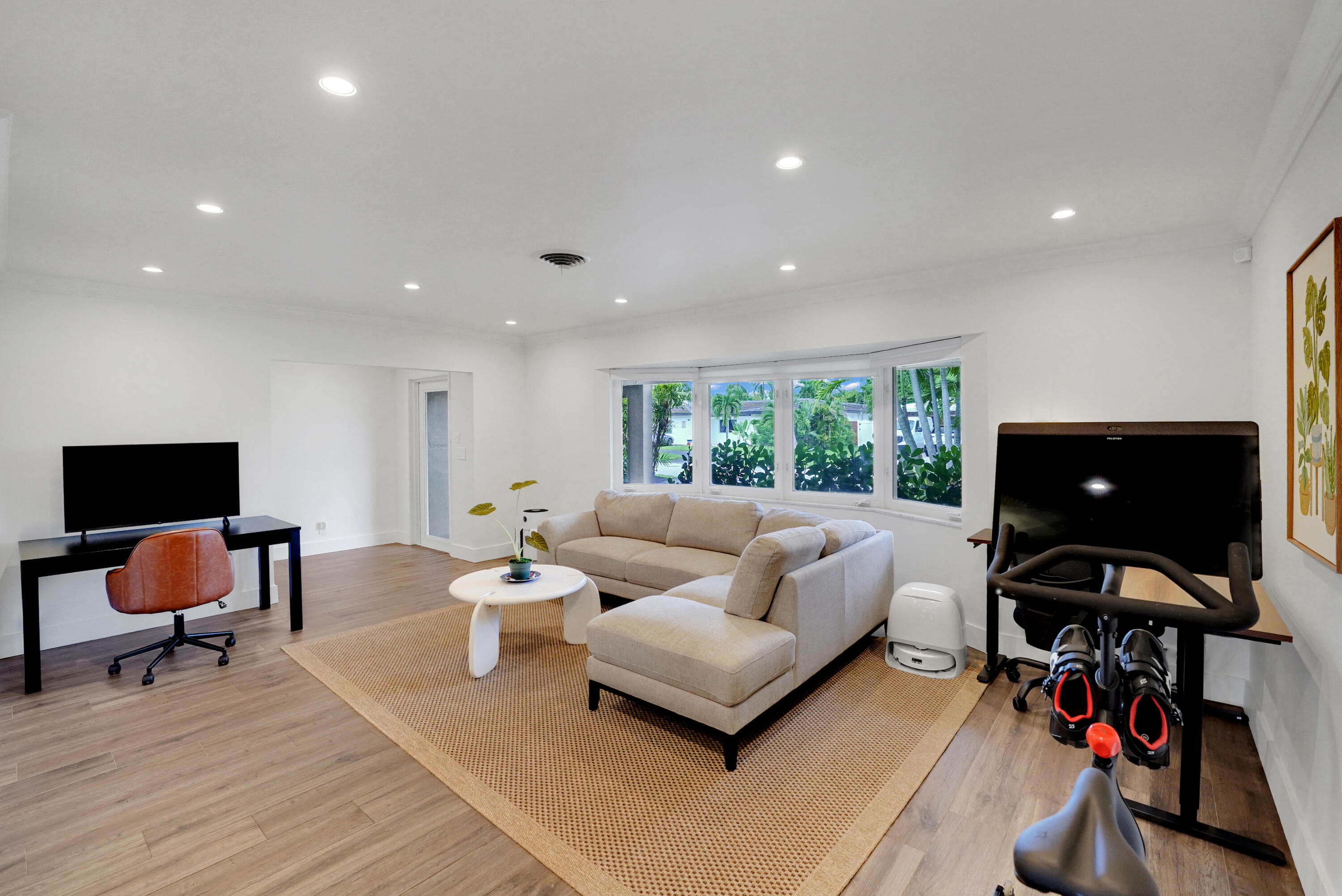 Open-concept interior featuring recessed lighting, and a multi-pane bay window