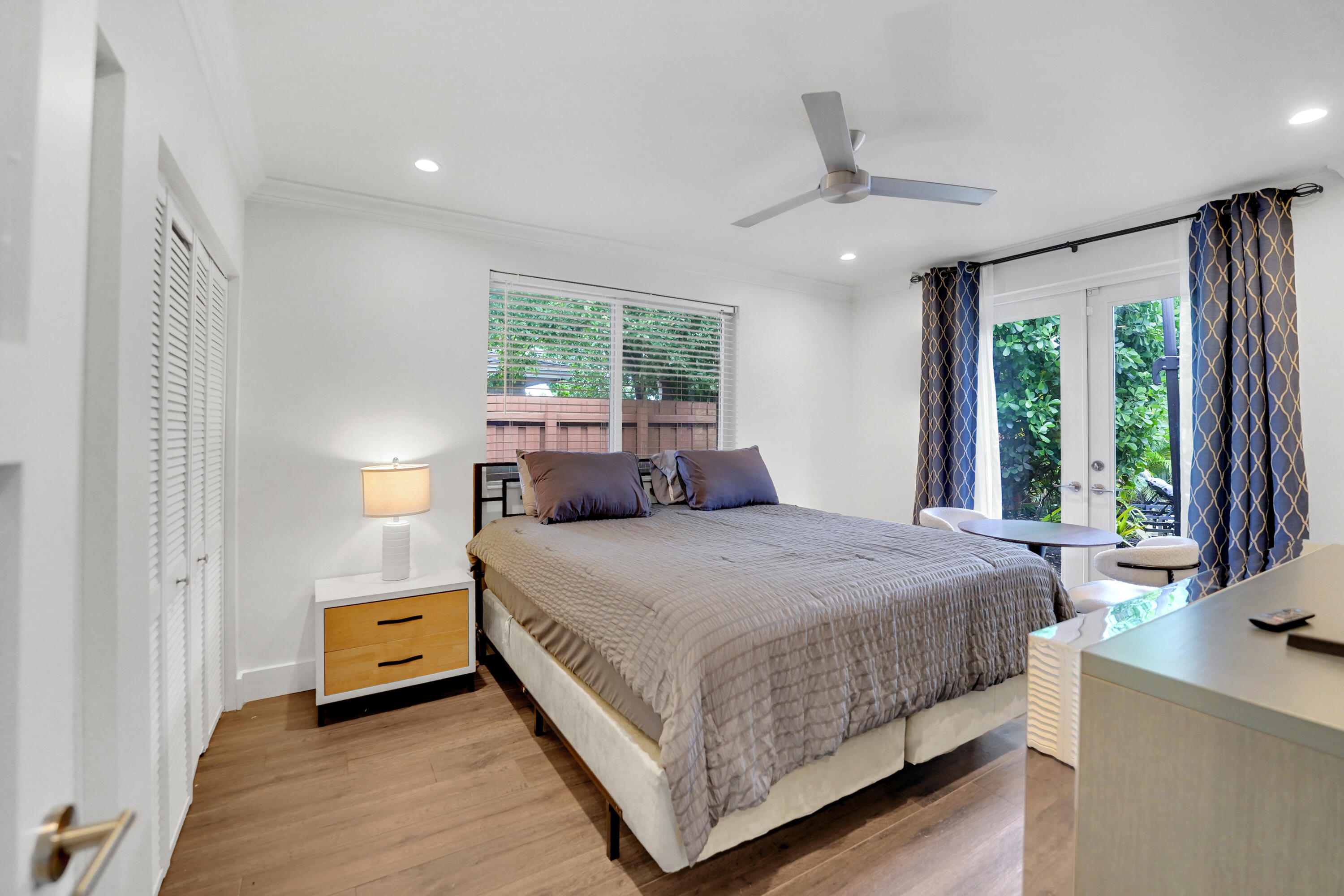 Guest bedroom with french doors to patio and pool.