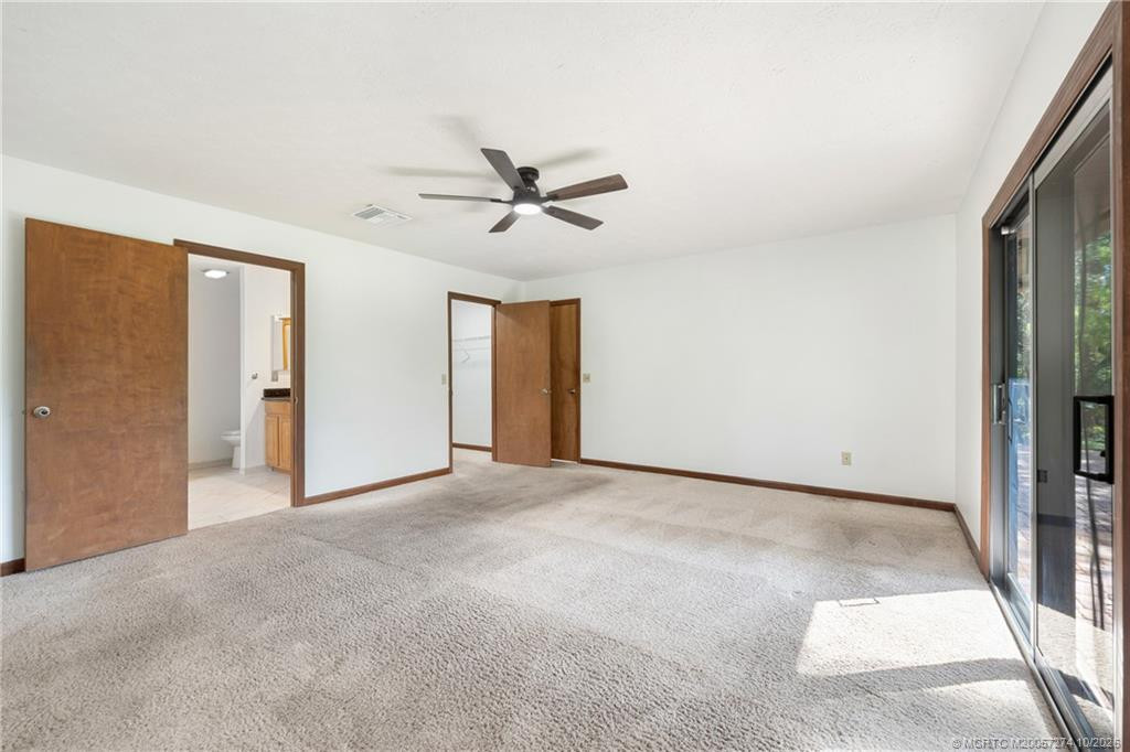 main bedroom with sliders to back patio and swim spa.