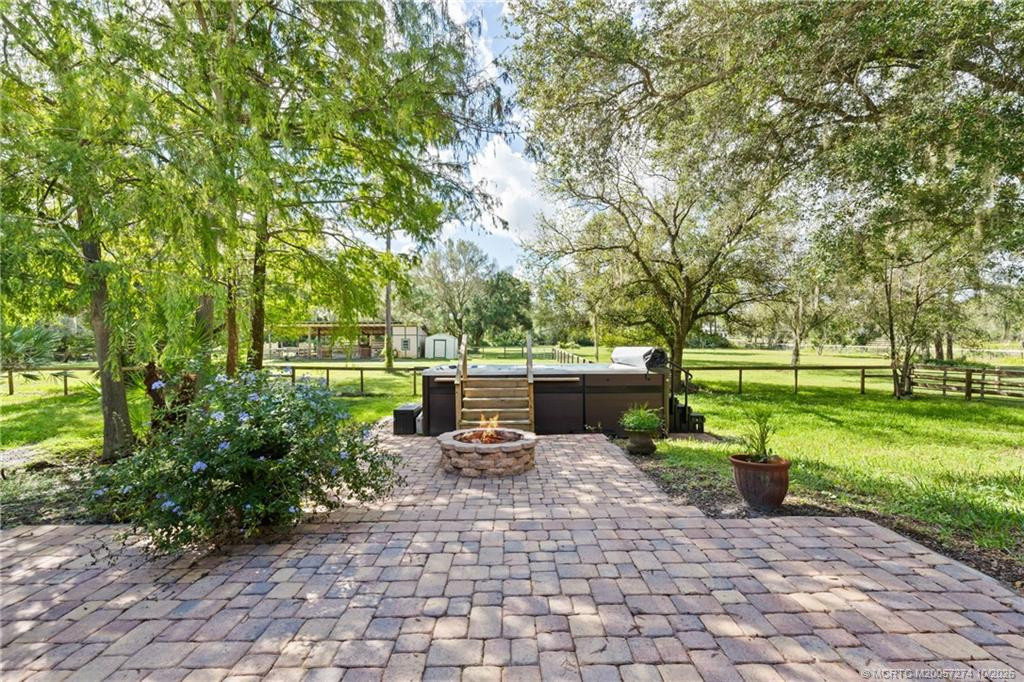 Paver patio with fire pit and swim spa.