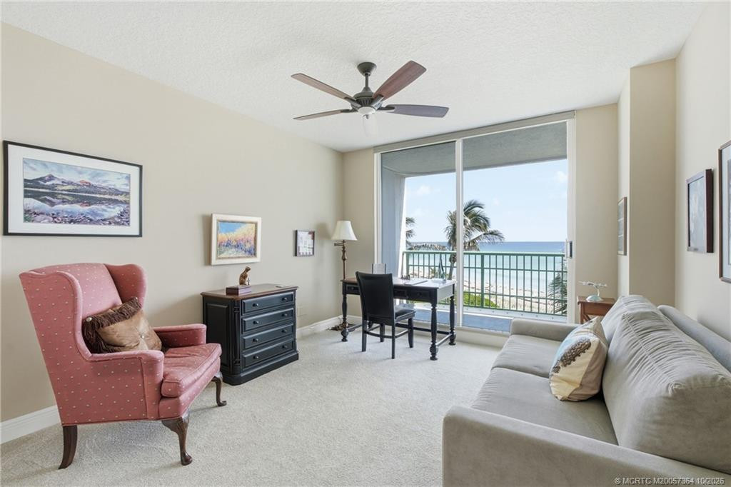 Versatile oceanfront room offers comfortable seating and flexible space for guests, a home office, or additional living area.