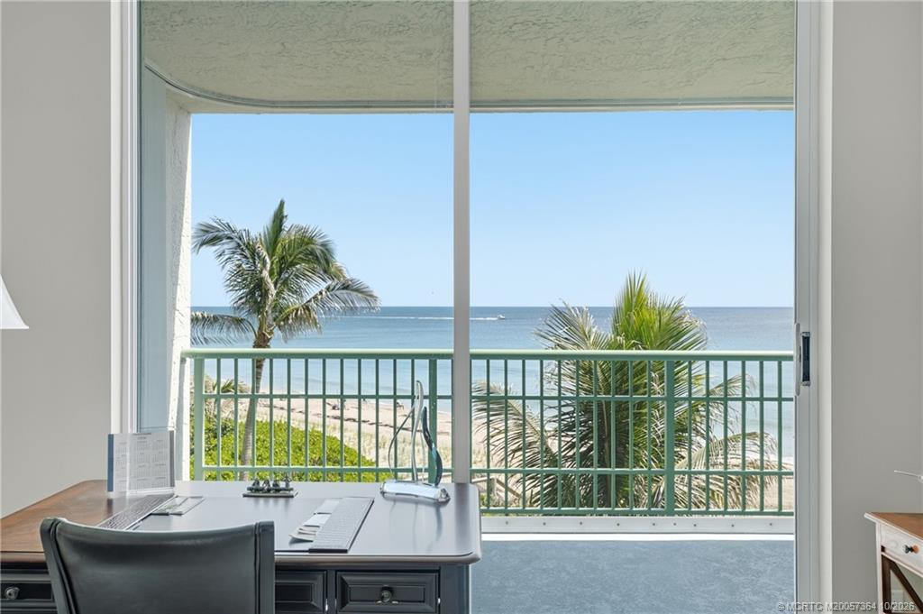 Enjoy beautiful Atlantic Ocean views and swaying palm trees from this oceanfront room, currently arranged as a home office.