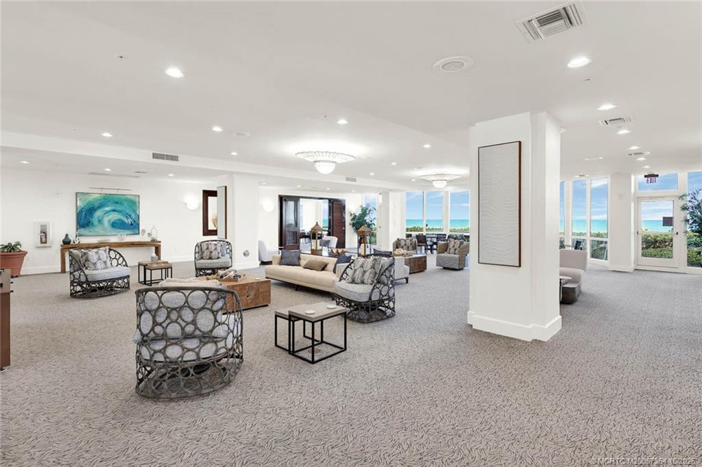 Enjoy an inviting oceanfront gathering space with comfortable seating, a bar area, and breathtaking ocean views.
