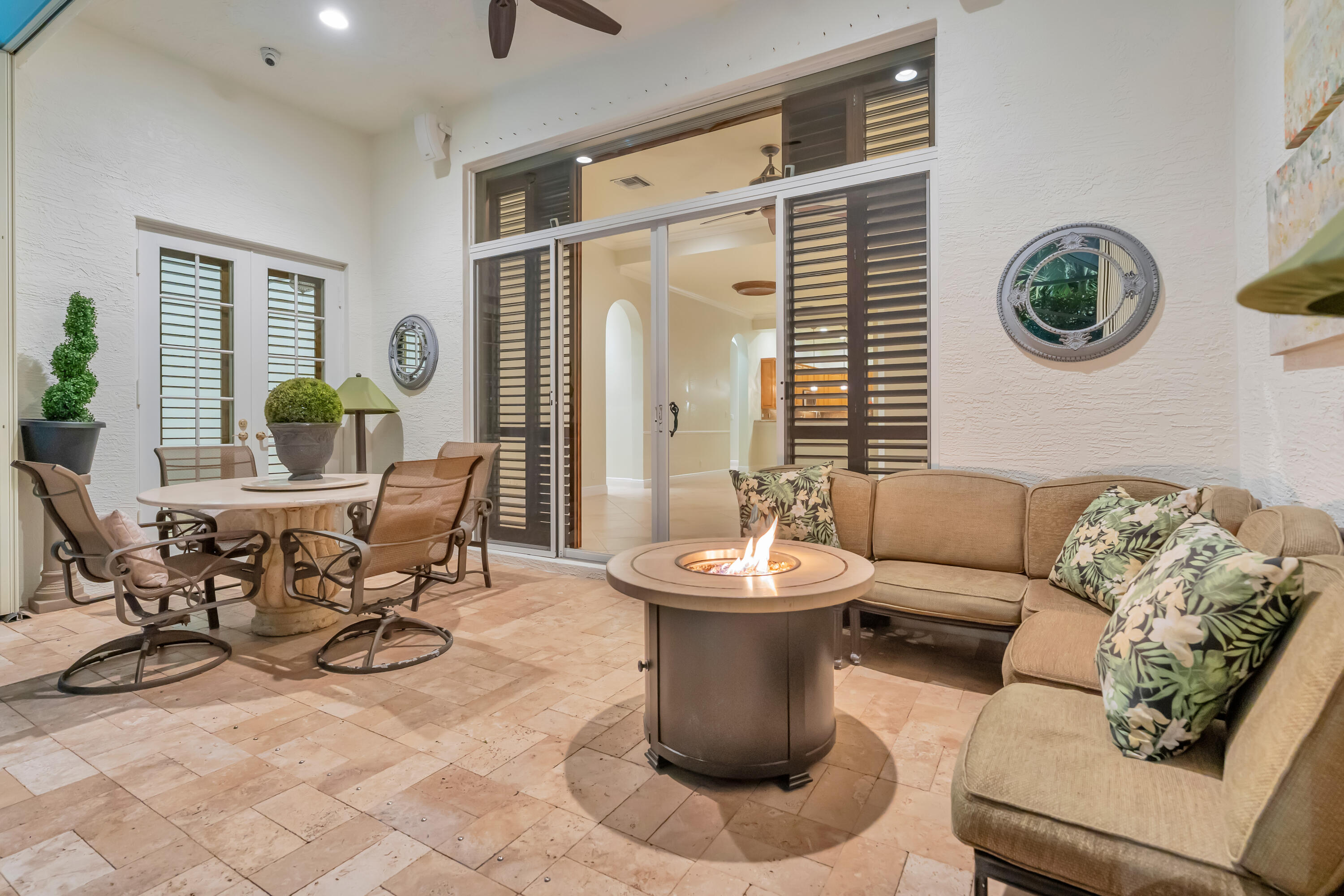 Gas fire pit in comfortable screened-in lanai. Furnishings to stay